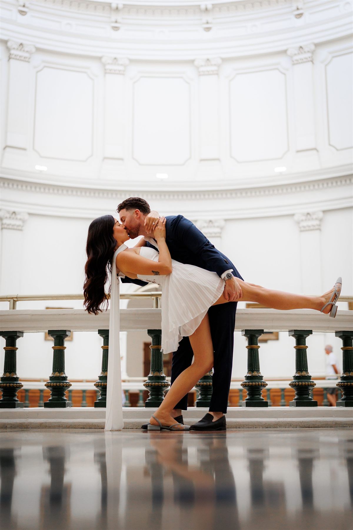 A couple kiss beneath the rotunda of the Texas State Capitol